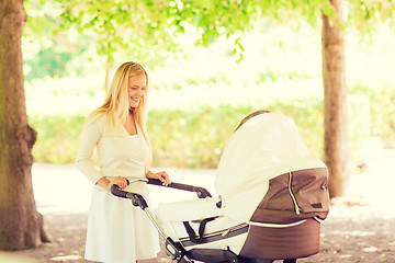 Image showing happy mother with stroller in park