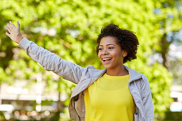 Image showing happy african american young woman in summer park