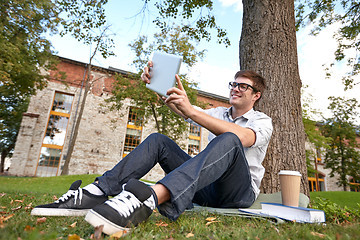 Image showing happy teenage boy with tablet pc taking selfie