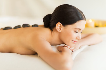 Image showing woman in spa with hot stones