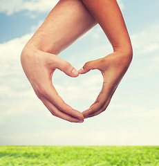 Image showing woman and man hands showing heart shape