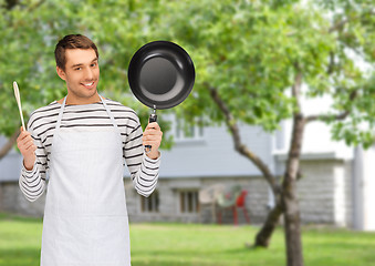 Image showing happy man or cook in apron with pan and spoon