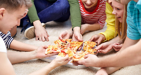 Image showing close up of happy friends eating pizza at home