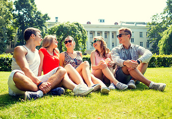 Image showing group of smiling friends outdoors sitting in park