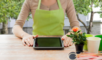 Image showing close up of woman or gardener with tablet pc