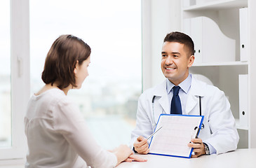 Image showing smiling doctor and young woman meeting at hospital