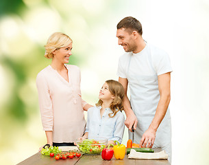 Image showing happy family cooking vegetable salad for dinner