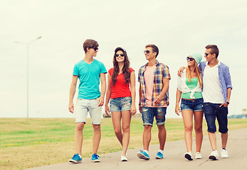 Image showing group of smiling teenagers walking outdoors