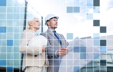 Image showing business people in helmets with blueprint