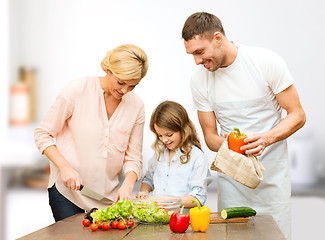 Image showing happy family cooking vegetable salad for dinner