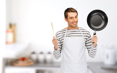 Image showing happy man or cook in apron with pan and spoon