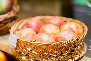 Image showing ripe pomegranates in basket at food market