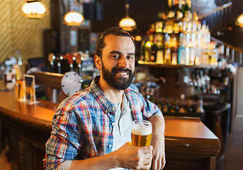 Image showing happy man drinking beer at bar or pub