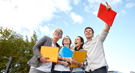 Image showing group of happy students with folders outdoors