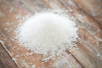 Image showing close up of white salt heap on wooden table