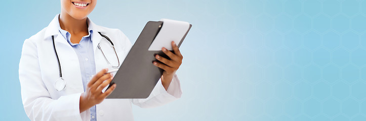 Image showing close up of smiling female doctor with clipboard