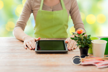 Image showing close up of woman or gardener with tablet pc