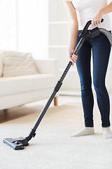 Image showing close up of woman with vacuum cleaner at home