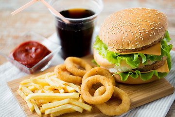 Image showing close up of fast food snacks and drink on table