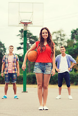 Image showing group of smiling teenagers playing basketball