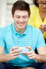 Image showing close up of young man with smartphone