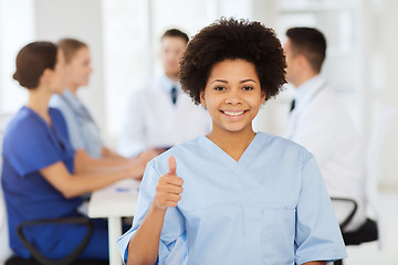 Image showing happy doctor over group of medics at hospital