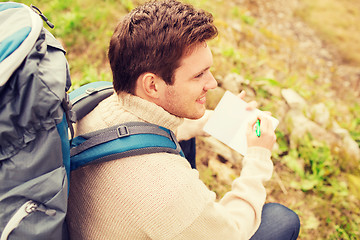 Image showing smiling man with backpack hiking