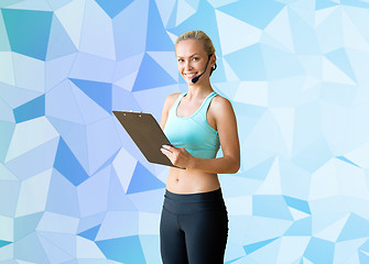 Image showing happy woman trainer with microphone and clipboard