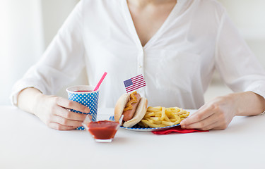 Image showing close up of woman eating hotdog and french fries