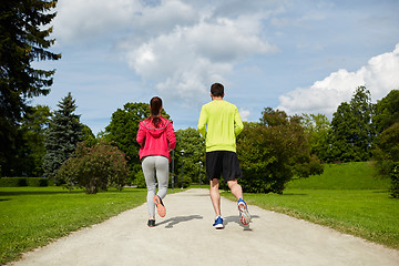 Image showing smiling couple running outdoors