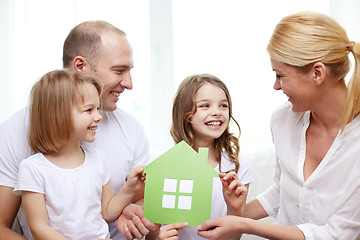 Image showing smiling parents and two little girls at new home