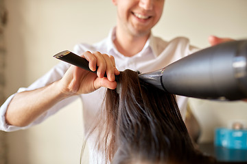 Image showing  close up of stylist making hairdo at salon