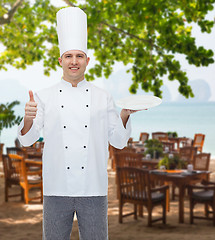 Image showing happy male chef cook showing thumbs up and plate