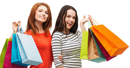 Image showing two smiling teenage girls with shopping bags