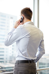Image showing businessman calling on smartphone in office