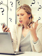 Image showing confused woman with cell phone