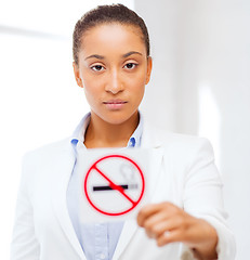 Image showing african woman with restriction no smoking sign