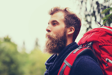 Image showing smiling man with beard and backpack hiking