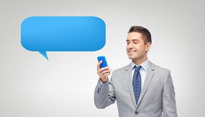 Image showing happy businessman texting message on smartphone