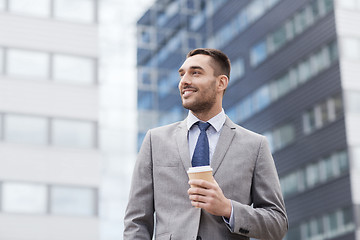 Image showing young smiling businessman with paper cup outdoors