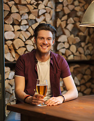 Image showing happy man drinking beer at bar or pub