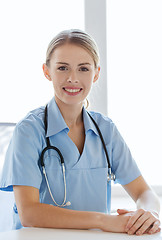 Image showing happy doctor or nurse with clipboard at hospital