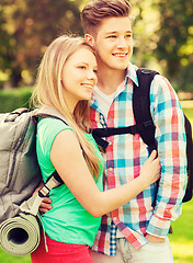 Image showing smiling couple with backpacks in nature