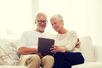 Image showing happy senior couple with tablet pc at home