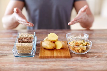 Image showing close up of male hands with carbohydrate food