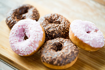 Image showing close up of glazed donuts pile on table
