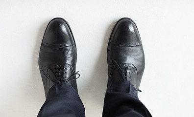 Image showing close up of man legs in elegant shoes with laces