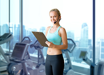 Image showing happy woman trainer with microphone and clipboard