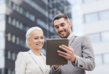 Image showing smiling businessmen with tablet pc outdoors