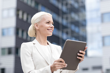 Image showing smiling businesswoman with tablet pc outdoors